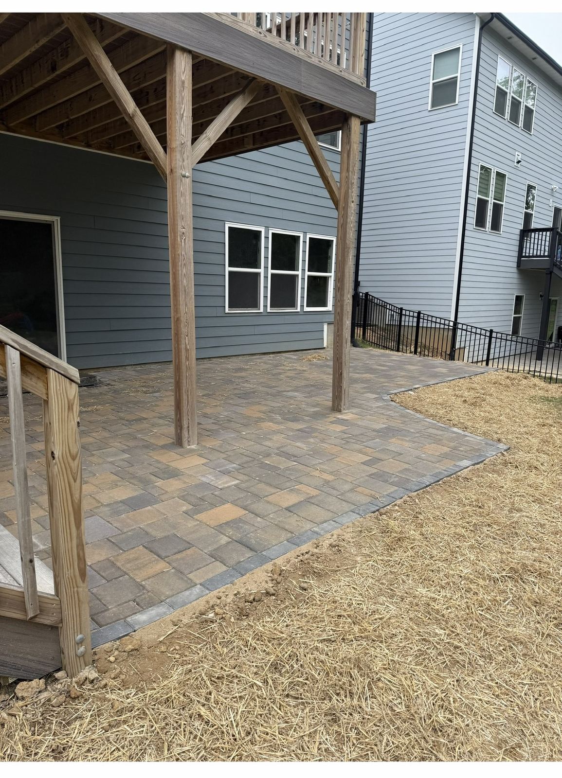 Paver stone patio installation under a covered deck