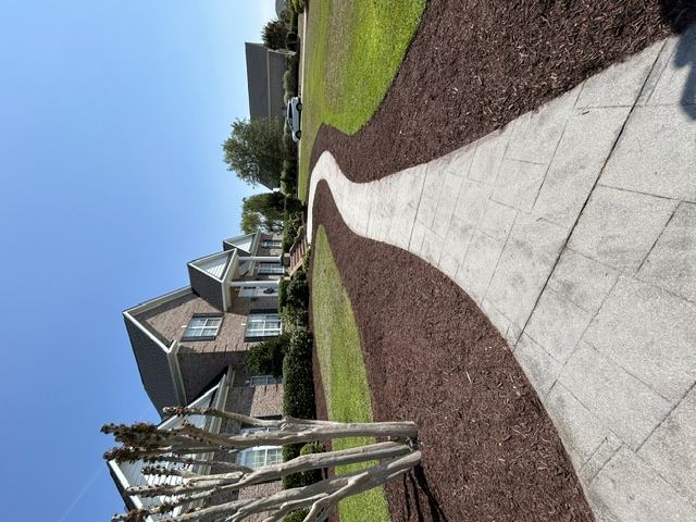 Custom paver walkway with mulch landscape beds