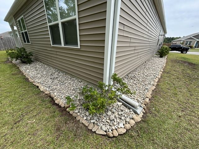 River rock foundation bed along the side of a house