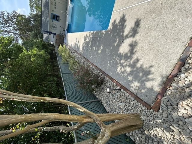 River rock border along a backyard pool patio
